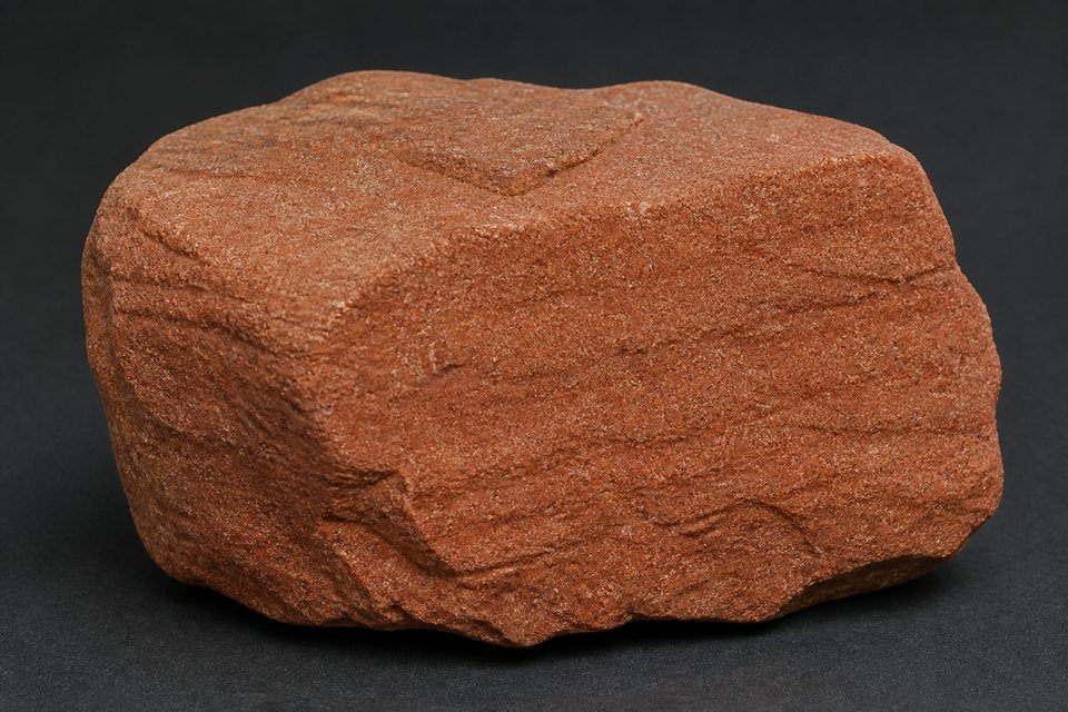 Original generated example image of warm red-brown sandstone with visible layers and blocky weathering